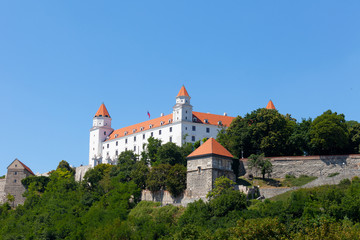 Fototapeta na wymiar Bratislava Castle against the blue sky in the sunny summer day