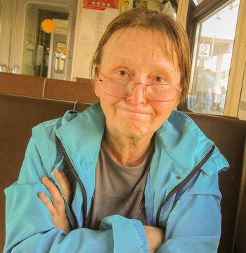 Older Woman Fold One's Arms And Purse One's Lips