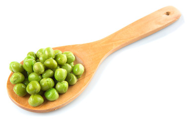 Green peas on wooden spoon over white background