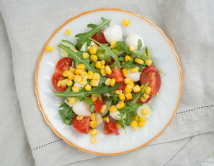 salad from arugula tomatoes mozzarella and corn