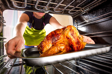 Cooking chicken in the oven at home. © Andrei Armiagov