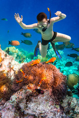 Snorkeler Maldives Indian Ocean coral reef. © Andrei Armiagov
