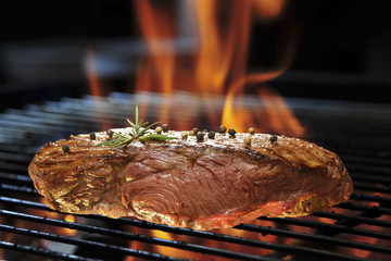 Grilled beef steak on the flaming grill