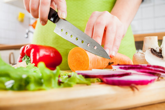 Woman's Hands Cutting Vegetables