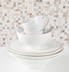 Stack of white dishes and cups