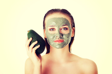 Spa woman in facial mask and avocado