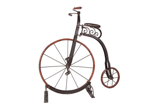 Historical children's high-wheel bicycle on a white background