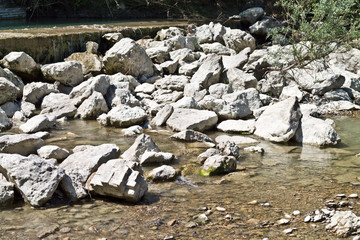 Low shot of pebbles and stones along a river