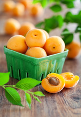 Fresh apricots in bowl on table, selective focus