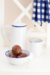 Chocolate ice cream in bowl on garden chair, selective focus