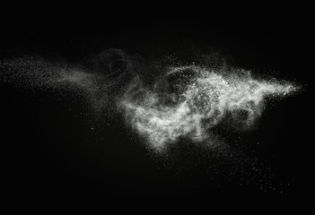 White powder exploding isolated on black - obrazy, fototapety, plakaty