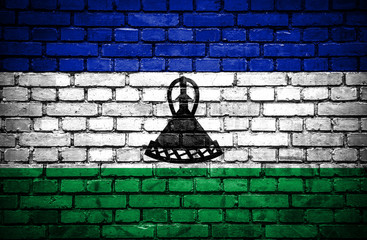 Brick wall with painted flag of Lesotho
