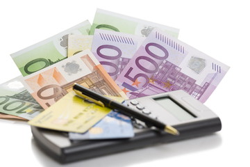 Banknotes, credit cards, calculator and pen