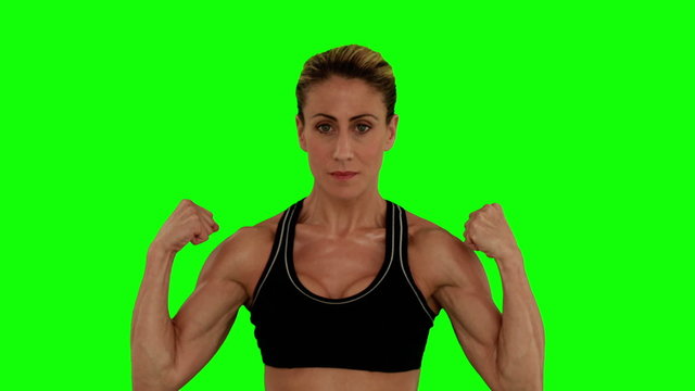 Super fit woman flexing her arms