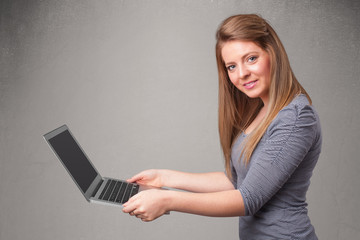 Young woman holding modern laptot