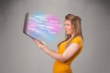 Casual woman holding laptop with exploding data and numers