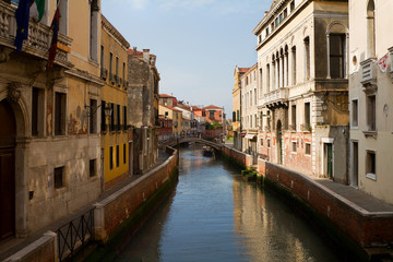 Fototapeta na wymiar Canal, bridge and ancient buildings in Venice.