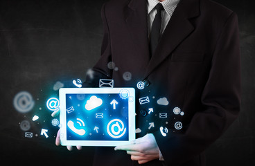 Person holding a tablet with blue technology icons and symbols