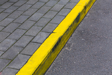 Yellow curb line on the road