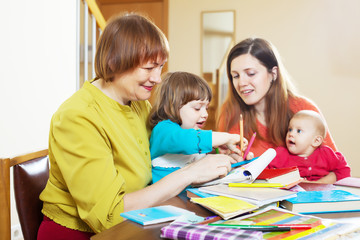 Fototapeta premium Happy woman with daughter and children playing at home