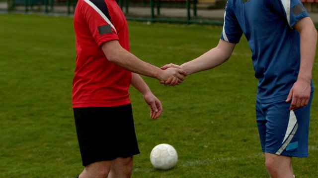 Football players shaking hands before a game