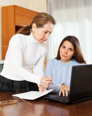 mature woman and yong daughter with notebook