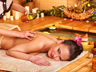 Obraz na płótnie Canvas Woman getting massage in bamboo spa.