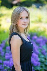 Portrait of the beautiful girl in flower garten