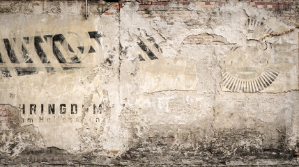 hundred years old advertising on a grungy wall, for backgrounds