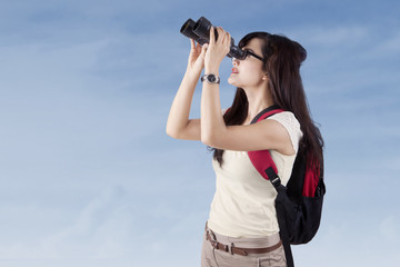 Student using binoculars outdoors