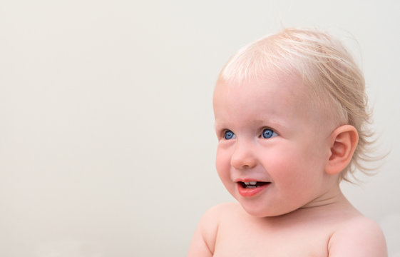 Smiling blond baby with blue eyes