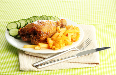 Roast chicken with french fries and cucumbers,