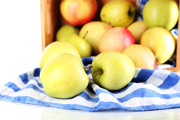 Juicy apples on napkin in box isolated on white