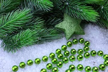 Christmas decorations and fir tree on light background