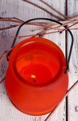 Bright icon-lamp with branches on wooden background