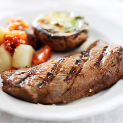 grilled steak with potatoes and stuffed mushroom