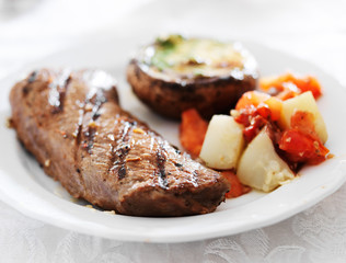 grilled steak with potatoes and stuffed mushroom