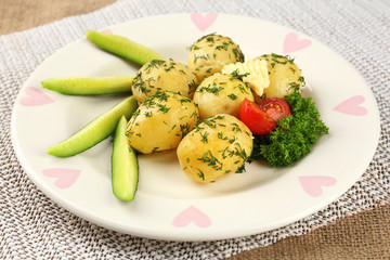 Young boiled potatoes on table, close up