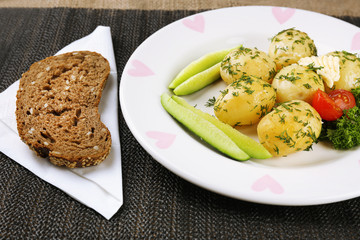 Young boiled potatoes on table, close up