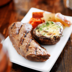 grilled steak with potatoes and stuffed mushroom