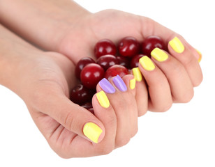 Female hands with stylish colorful nails holding ripe berries,