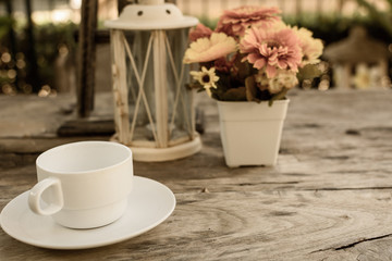 coffee on wooden table with flower