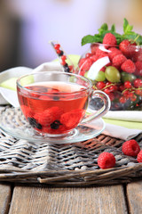 Fruit red tea with wild berries in glass cup,