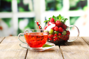 Fruit red tea with wild berries in glass cup,