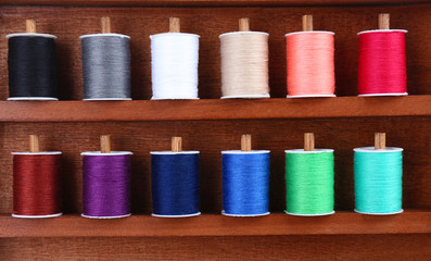 Colorful threads for needlework in wooden box close up