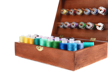 Colorful threads for needlework in wooden box close up