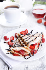 Delicious pancakes with berries on table close-up