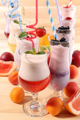 Delicious milkshakes on wooden table, close-up