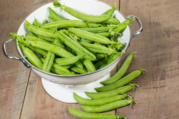 Fresh peas in a white colander