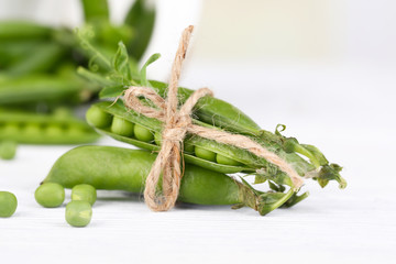 Fresh green peas on wooden table